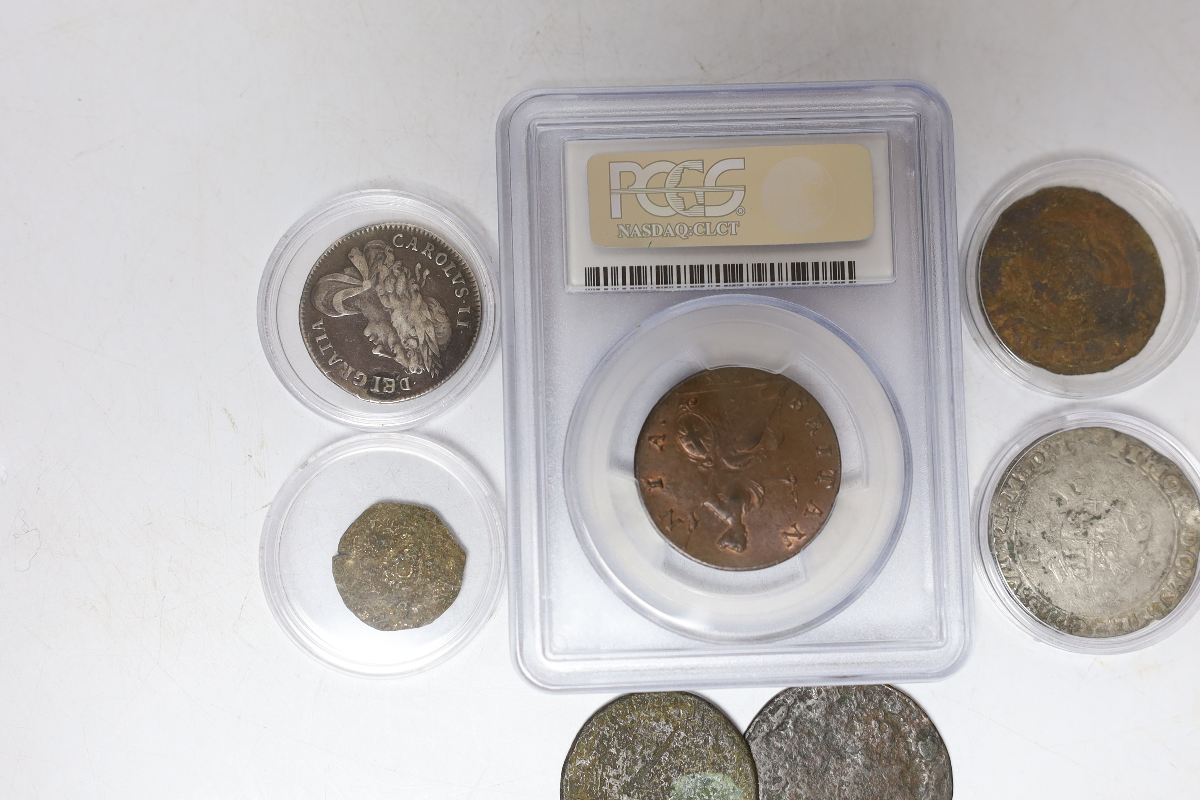 Seven coins including; a Charles II 1663 shilling, an Edward VI silver shilling, a George II 1735 half penny (PCGS graded MS65BN) together with four other coins